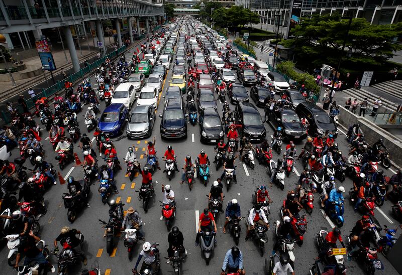 Anti-government protesters block a road with cars and motorcycles as they take part in a 'car mob' rally along several roads of Bangkok, in Thailand.  Thousands demonstrators called for the resignation of the Thai prime minister amid a surge of Covid-19 cases in the country.