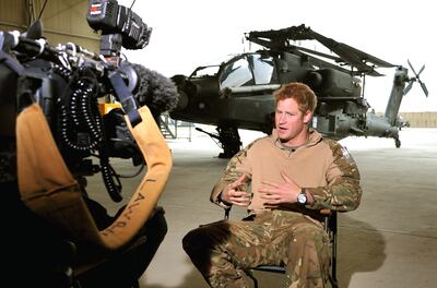 Prince Harry gives a TV interview in a helicopter hangar at Camp Bastion in Afghanistan in December 2012. Getty