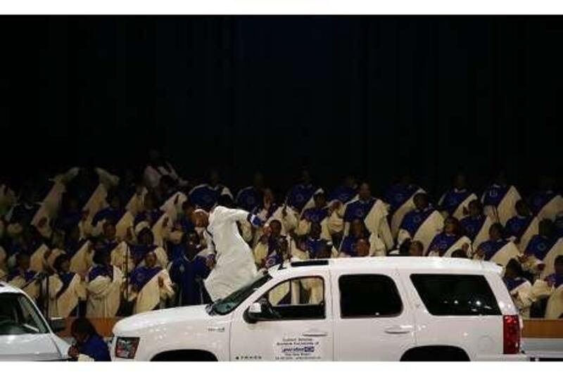 A pastor prays for the future of the US auto industry during a special service in Detroit, Michigan, earlier this month.