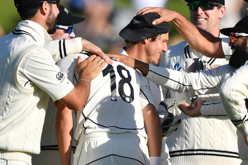 New Zealand's Trent Boult (18) celebrates with teammates after India captain Virat Kohli was caught, a significant moment on day three. AFP