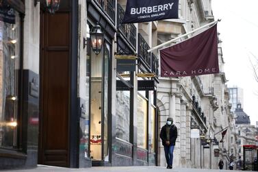 People walk by closed shops along Regent Street in London. Britain's third national lockdown has forced non-essential retailers to close their shops once again, along with hairdressers, gyms, restaurants and hospitality businesses. Reuters