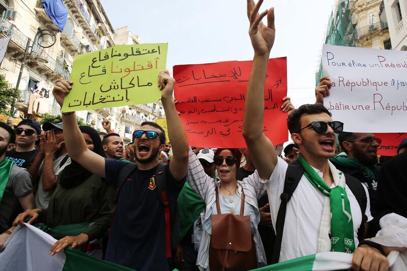 Algerian protesters carrying national flags chant slogans during a students' demonstration against postponing the presidential elections in Algiers, Algeria. According to reports, Algeria will hold elections on 12 December, after the July vote was postponed, amid political vacuum since president Abdelaziz Bouteflika resigned.  EPA