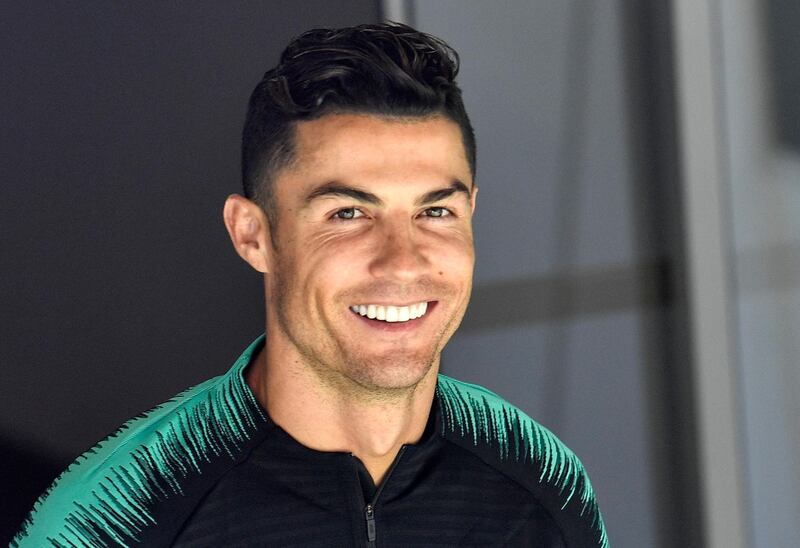 Portugal's Cristiano Ronaldo smiles when he arrives to a training session at the Bessa stadium in Porto. AP Photo