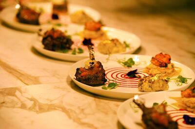 Non-vegetarian starters include lamb chops, lobster and marinated chicken thigh, served around a spiral of sauce. Photo: Varq