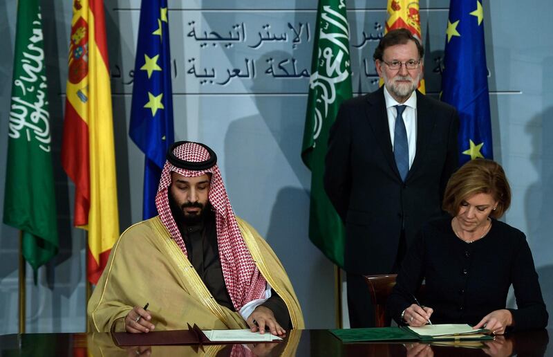 Saudi Arabia's crown prince Mohammed bin Salman (L) and Spanish Minister of Defence Maria Doroles de Cospedal sign agreements as Spanish Pime Minister Mariano Rajoy looks on at La Moncloa palace in Madrid on April 12, 2018.
Prince Mohammed arrived in Spain late on April 11, 2018 hot on the heels of a three-day official visit to France and after a tour lasting several weeks of Egypt, the United States and Britain that saw the self-styled moderniser sign multimillion-dollar deals. Madrid is the last stop of his global diplomatic charm offensive in a bid to project a new liberal image of his conservative kingdom.

 / AFP PHOTO / OSCAR DEL POZO