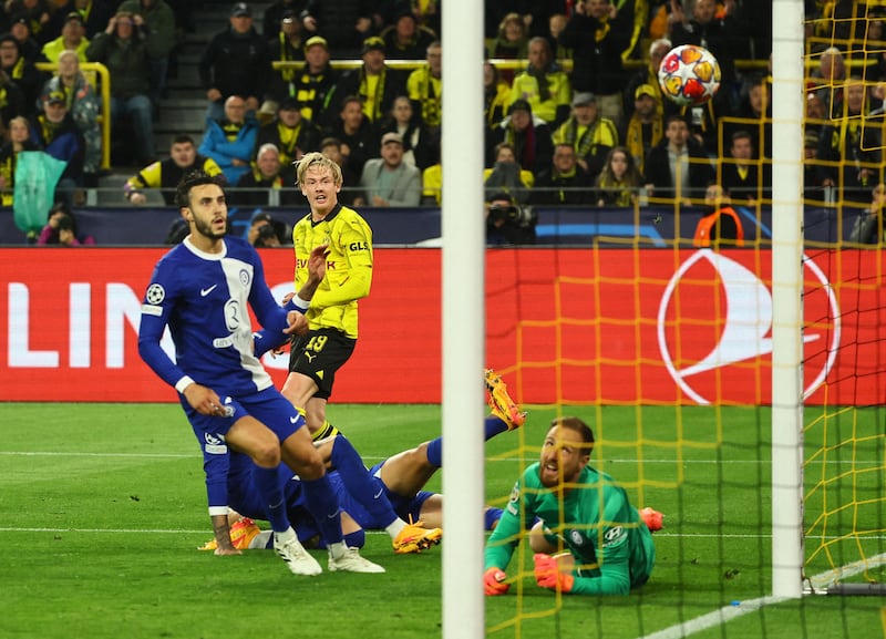 Julian Brandt scores Dortmund's opening goal of the second leg against Atletico. Reuters