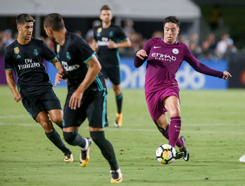 (FILES) This file photo taken on July 26, 2017 shows Manchester City's Samir Nasri (R) driving the ball against Real Madrid during the International Champions Cup football match in Los Angeles, California. 
Former French international midfielder Samir Nasri  signed on August 21, 2017 a two year deal to join Turkish top flight side Antalyaspor from Manchester City, the club said. / AFP PHOTO / RINGO CHIU