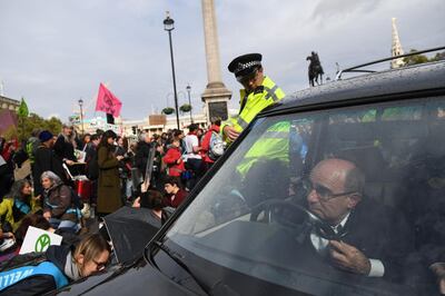 LONDON, ENGLAND - OCTOBER 07: A man drives a hearse as Extinction Rebellion protesters gather in Trafalgar Square on October 7, 2019 in London, England. Climate change activists are gathering to block access to various government departments as they start a two week protest in central London (Photo by Chris J Ratcliffe/Getty Images) *** BESTPIX ***