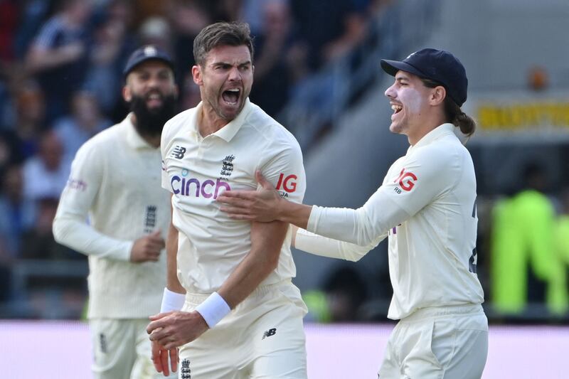 England's James Anderson, centre, celebrates taking the wicket of India's captain Virat Kohli on the first day of the third Test in Headingley. AFP