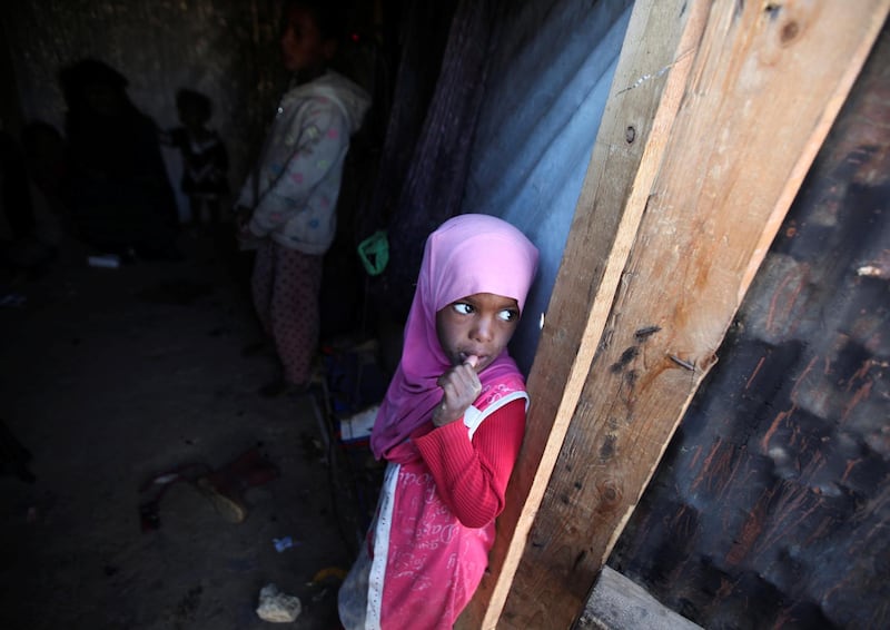 A girl stands in her family's hut at a camp for internally displaced people in Khamir of the northwestern province of Amran, Yemen. Reuters