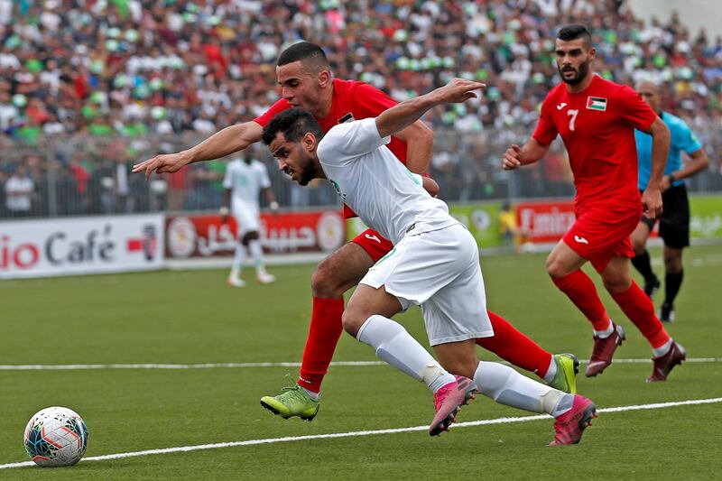West Bank Palestine's Mohammed Yamin in action with Saudi Arabia's Abdulfattah Asiri - FIFA World Cup 2022 and Asian Cup Qualifier - Palestine v Saudi Arabia - Faisal Al-Husseini International Stadium, Al-Ram. REUTERS