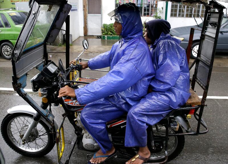 Residents wear raincoats during rain as Typhoon Mangkhut nears Tuguegarao, Cagayan province, northeastern Philippines. Aaron Favila / AP Photo