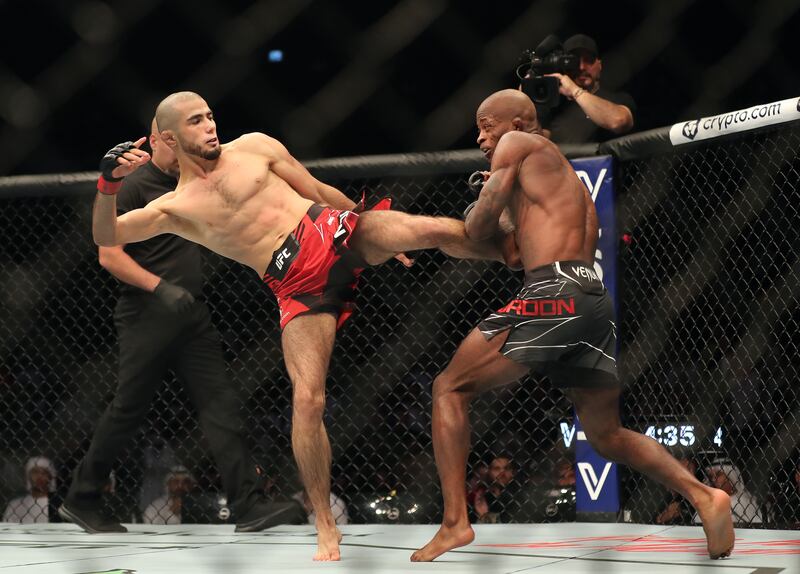 Muhammad Mokaev, red, takes on Malcolm Gordon at UFC 280 in Abu Dhabi. Chris Whiteoak / The National