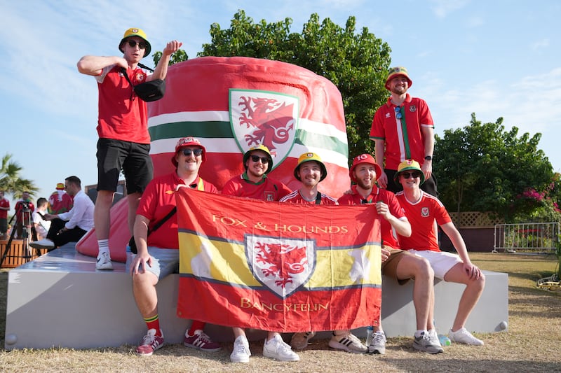 Wales fans gather next to a giant bucket hat decorated with their country's flag, at the Corniche Walk Way Park in Doha, ahead of their Group B game against Iran. PA