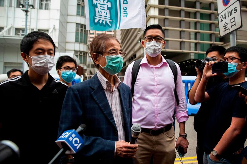 CORRECTION / Former lawmaker and pro-democracy activist Martin Lee (centre L) talks to members of the media as he leaves the Central District police station in Hong Kong on April 18, 2020, after being arrested and accused of organising and taking part in an unlawful assembly in August last year. Police in Hong Kong carried out a sweeping operation against high-profile democracy campaigners on April 18, arresting 14 activists on charges related to massive protests that rocked the Asian financial hub last year. / AFP / ISAAC LAWRENCE
