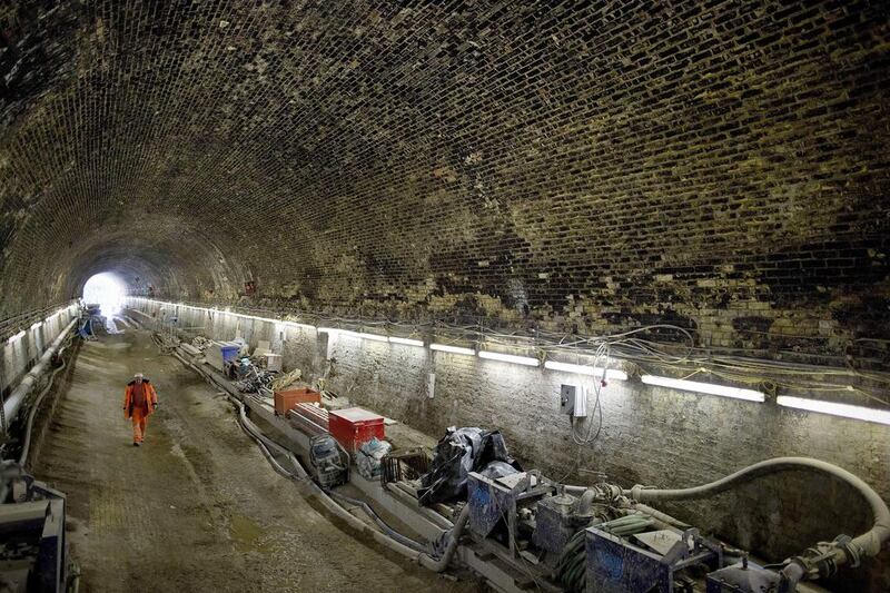 A worker walks at the Connaught Tunnel section of the Crossrail project. Work is taking place to create a new platform and passenger tunnels for a new Crossrail station. Adrian Dennis / AFP