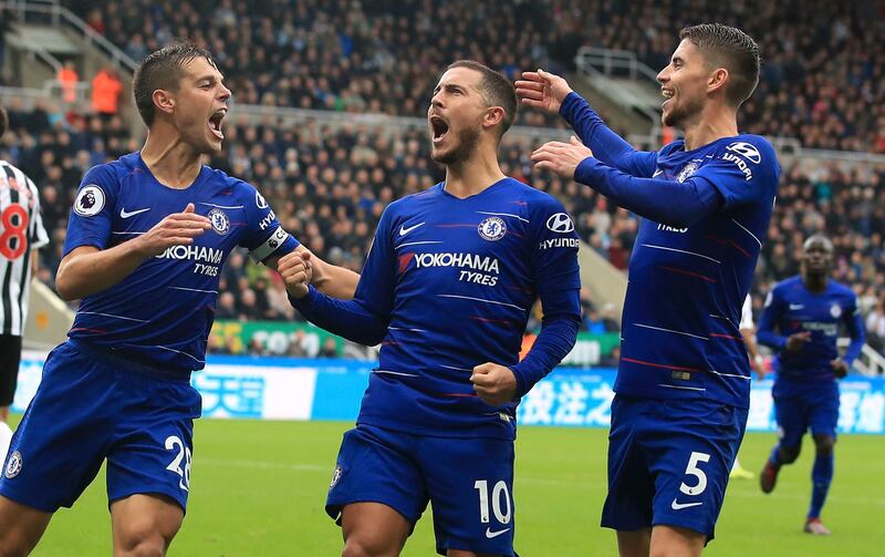 Chelsea's Eden Hazard, centre, celebrates scoring his side's first goal of the game against Newcastle, with team-mates Cesar Azpilicueta, left, and Filho Jorge Jorginho, during their English Premier League soccer match at St James' Park in Newcastle, England, Sunday Aug. 26, 2018. (Owen Humphreys/PA via AP)