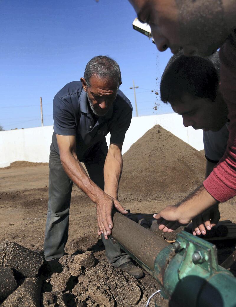 Gazan Entrepreneur Project Turns Olive Waste into a Valuable Resource. The team uses its machine to produce green cakes. Photo by Muhammad Shehada