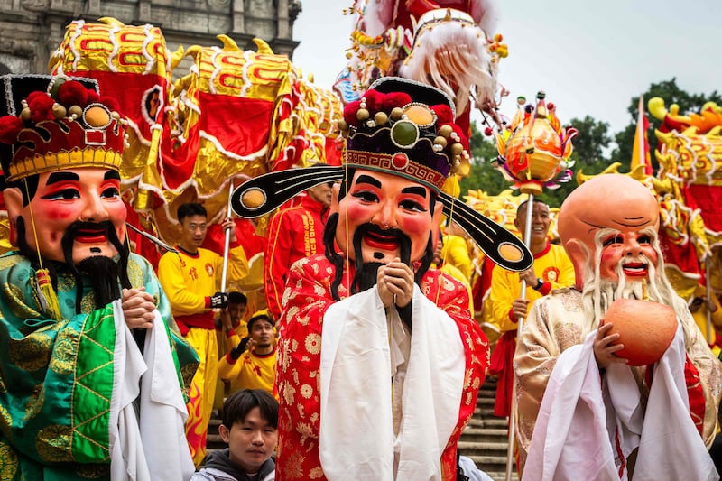 A human puppet of Tsai Shen Yeh, the God of Wealth, parades in front of the St Paul's Ruins during celebrations in Macau on the first day of the Lunar New Year of the Dragon. AFP