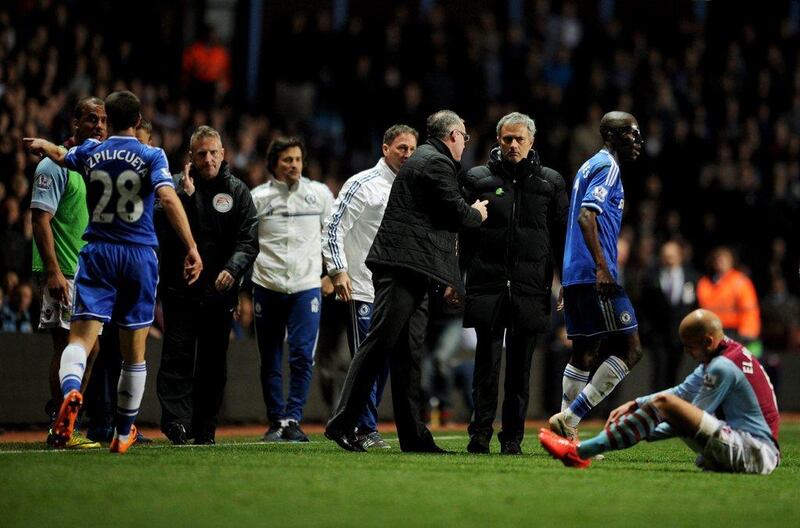 Paul Lambert manager of Aston Villa and Jose Mourinho manager of Chelsea in discussion after Ramires of Chelsea, second from right, challenges Karim El Ahmadi of Aston Villa, right, during their Premier League match on March 15, 2014 in Birmingham, England. Chris Brunskill/Getty Images