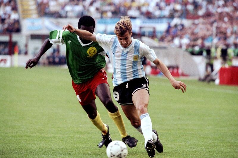 8 Jun 1990:  Claudio Caniggia of Argentina is shadowed by Benjamin Massing of Cameroon during the World Cup first round match at the Giuseppe Meazza Stadium in Milan, Italy. Cameroon won the match 1-0. \ Mandatory Credit: Allsport UK /Allsport