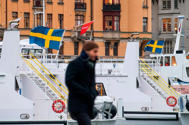 The national Swedish flags fly on top of commuter ferries in Stockholm. AFP
