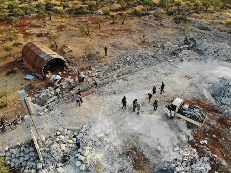 TOPSHOT - An aerial view taken on October 27, 2019 shows the site that was hit by helicopter gunfire which reportedly killed nine people near the northwestern Syrian village of Barisha in the Idlib province along the border with Turkey, where "groups linked to the Islamic State (IS) group" were present, according to a Britain-based war monitor with sources inside Syria.  The helicopters targeted a home and a car on the outskirts of Barisha, the Syrian Observatory for Human Rights said, after US media said IS leader Abu Bakr al-Baghdadi was believed to be dead following a US military raid in the same province. Observatory chief Rami Abdel Rahman said the helicopters likely belonged to the US-led military coalition that has been fighting the extremist group in Syria. / AFP / Omar HAJ KADOUR
