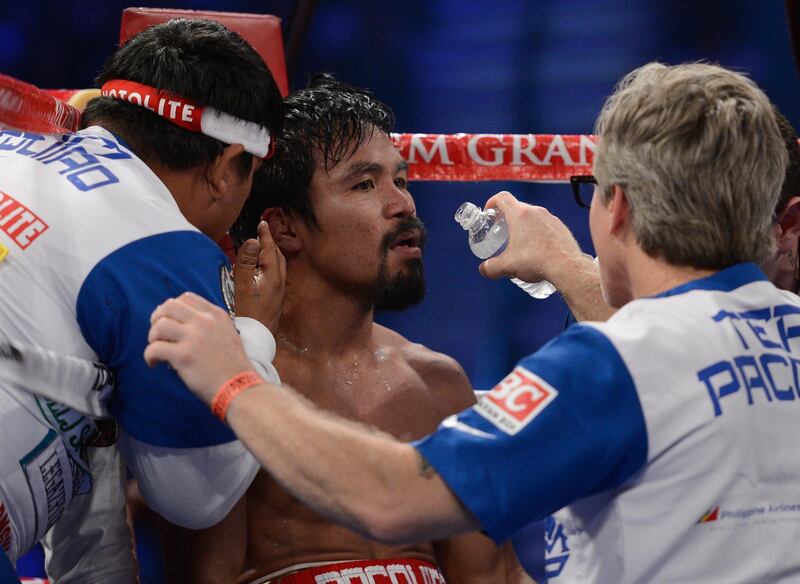 LAS VEGAS, NV - JUNE 09:  (R-L) Trainer Freddie Roach gives Manny Pacquiao instruction between rounds during his bout against Timothy Bradley at MGM Grand Garden Arena on June 9, 2012 in Las Vegas, Nevada.  (Photo by Kevork Djansezian/Getty Images)