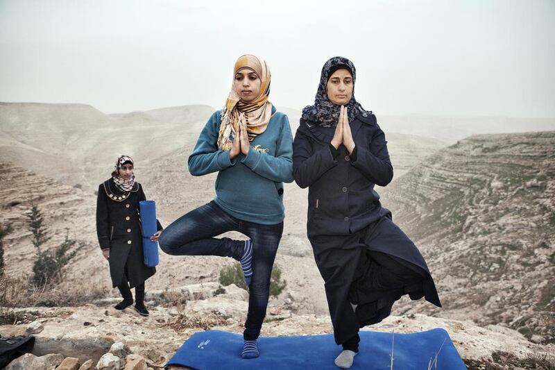 Hyatt (left) recently took a yoga lesson from a visiting American yoga instructor. She is now teaching residents of her village, Zataara, a small village on the outskirts of Bethlehem in the West Bank. The women are increasing in number each week-and they say it is proving to be the ultimate release. Courtesy Tanya Habjouqa