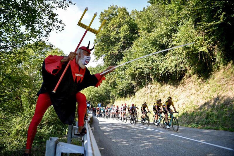 Cycling fan Didi Senft, aka El Diablo, cheers on the riders. AFP