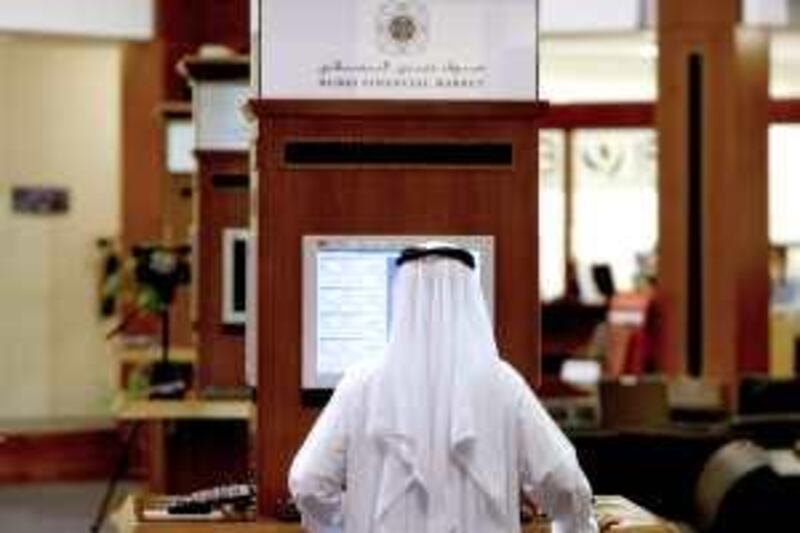 DUBAI - SEPTEMBER 28,2009 - A trader is seen at the trading floor of the Dubai Financial Market in Dubai. ( Paulo Vecina/The National ) *** Local Caption ***  PV Trading 1.jpg