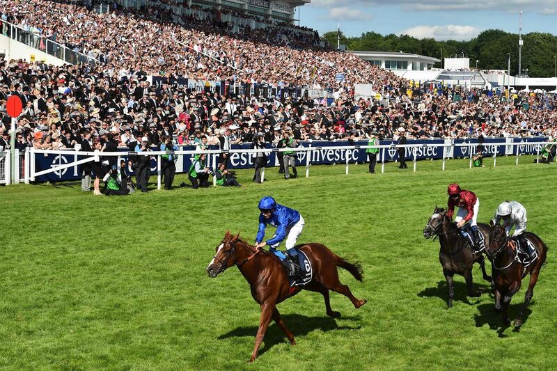 Jockey William Buick crosses the line on Masar for breeder Godolphin, winning the Derby on the second day of the Epsom Derby Festival in Surrey, southern England on June 2, 2018.   / AFP / Glyn KIRK
