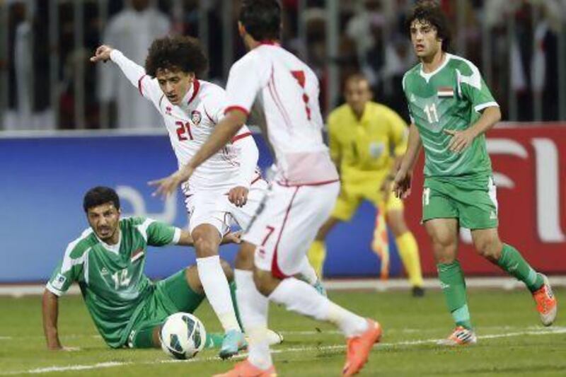 UAE's Omar Abdulrahman (21) prepares to kick the ball to score a goal past Iraq's Salam Shaker (L) during their Gulf Cup Tournament final soccer match on Friday. UAE won in extra time, 2-1.