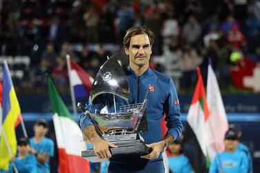 Roger Federer with the Dubai Duty Free Tennis Championships trophy in 2019 after winning the title for an eighth time. AFP