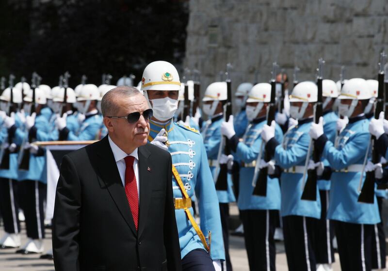 Turkey's President Recep Tayyip Erdogan inspects a military honour guard as he arrives at the parliament for a ceremony, in Ankara, Turkey, Wednesday, July 15, 2020. AP