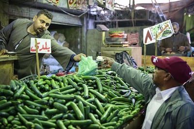 A shopper in Giza pays for vegetables with Egyptian pound banknotes. Bloomberg