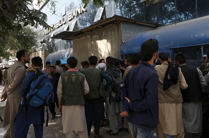 Afghans wait in long lines for hours to try to withdraw money, in front of Kabul Bank, in Kabul, Afghanistan on Sunday. AP