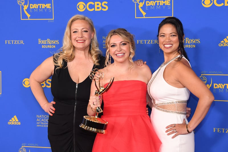 Whitney Nevill-Wallace, Erin Johnson and Leslie Kawaguchi pose with their Emmy for outstanding entertainment news series. Reuters
