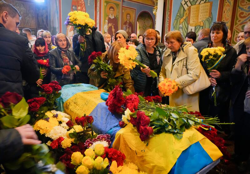 People pay their respects during the funeral for Ukrainian serviceman Ruslan Borovyk in St Michael's Cathedral in Kyiv. AP