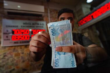 A currency exchange worker counts Turkish lira banknotes in Istanbul. The sacking of Turkish Central Bank governor Naci Agbal triggered a sharp sell-off in the Turkish lira. Photo: AFP