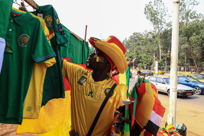 A vendor sorts out the Cameroon football merchandise in Yaounde. AFP