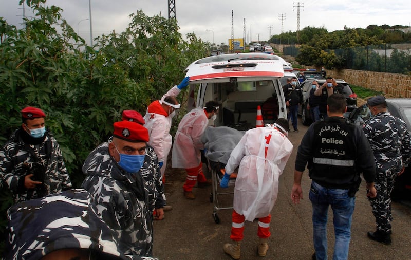 Medics load the body of Lebanese activist and intellectual Lokman Slim into an ambulance. AFP