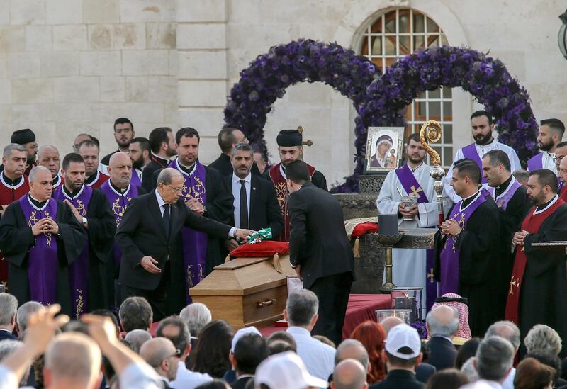 Lebanese President Michel Aoun lays the republic scarf on Sfeir's coffin. EPA