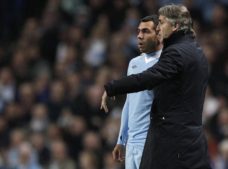 Roberto Mancini, right, and Carlos Tevez had a tumultuous time together at Manchester City. Tonight they will be on opposing sides. Darren Staples / Reuters