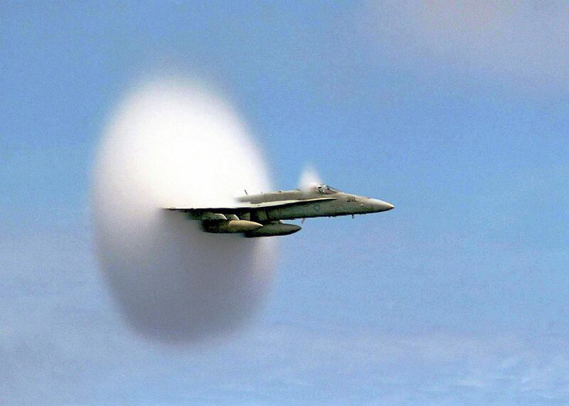 POY*99 - An F/A-18 Hornet assigned to Strike Fighter Squadron One Five One (VFA-151) emerges from a cloud created when it broke the sound barrier in the skies over the Pacific Ocean, July 7, 1999.  VFA-151 is currently deployed with USS Constellation (CV64) which arrived in Tokyo Friday July 23, 1999.  (Photo by John Gay/US Navy)