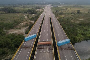 A gas tank and shipping containers obstructing passage to Venezeula are seen on the Tienditas International Bridge in an aerial photograph taken over Cucuta, Colombia, on Wednesday, Feb. 6, 2019. Venezuela's Nicolas Maduro has an offer for the U.S.: If you want to bring humanitarian aid into the country, you must lift economic sanctions first. Photographer: Ivan Valencia/Bloomberg