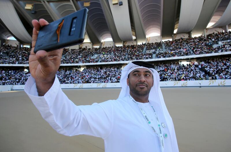 An Emirati official takes a selfie ahead of Pope Francis's Mass at Zayed Sports City.  AP