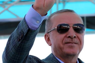 Turkey's President Recep Tayyip Erdogan gestures as he addresses his supporters in Bursa, Turkey, Sunday, Aug. 4, 2019. Erdogan has renewed a pledge for a cross-border military operation into northeastern Syria and said: "We've entered Afrin, Jarablus, al-Bab. Now we will enter the east of the Euphrates." (Presidential Press Service via AP, Pool)