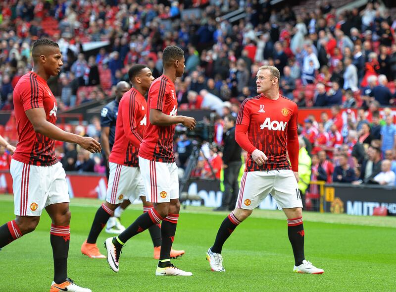 Manchester United's Wayne Rooney, right, and his teammates leave the pitch as fans are evacuated from Old Trafford due to a bomb scare that saw the Premier League game against Bournemouth called off in May, 2016. EPA