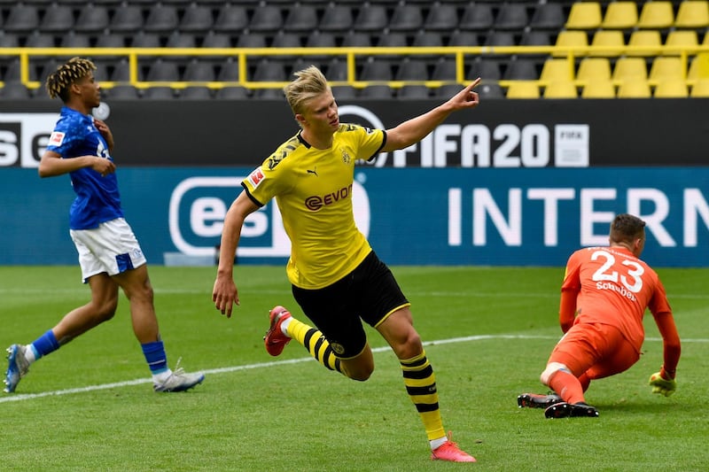 DORTMUND, GERMANY - MAY 16: Erling Haaland of Borussia Dortmund celebrates scoring his team's first goal during the Bundesliga match between Borussia Dortmund and FC Schalke 04 at Signal Iduna Park on May 16, 2020 in Dortmund, Germany. The Bundesliga and Second Bundesliga is the first professional league to resume the season after the nationwide lockdown due to the ongoing Coronavirus (COVID-19) pandemic. All matches until the end of the season will be played behind closed doors. (Photo by Martin Meissner/Pool via Getty Images)